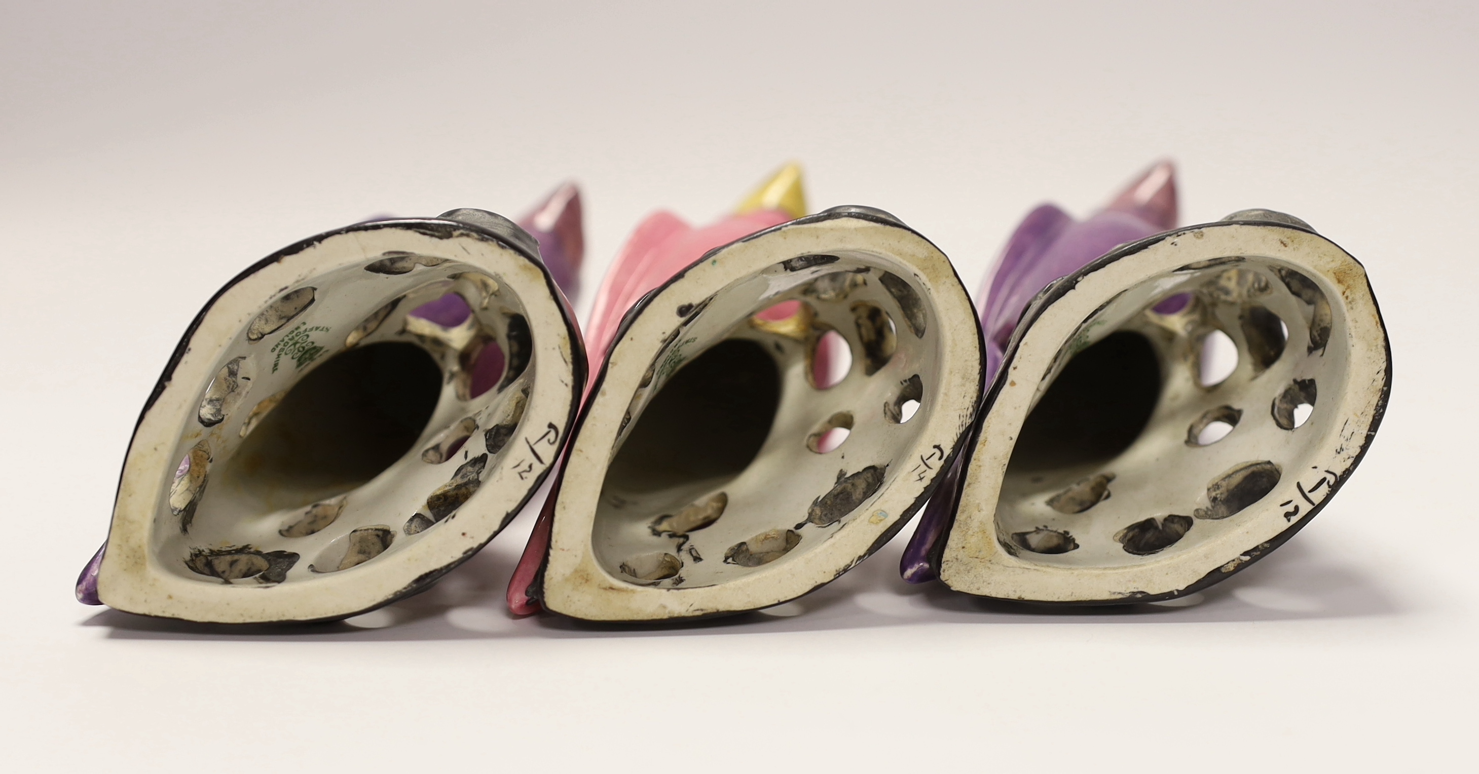 Three Crown Staffordshire parrots with purple and pink glazed, each stamped, 19cm high